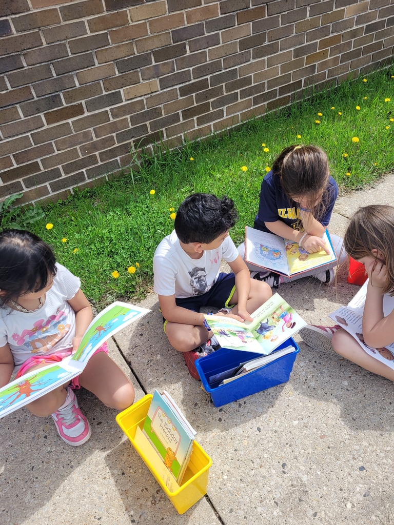 First graders reading outside.
