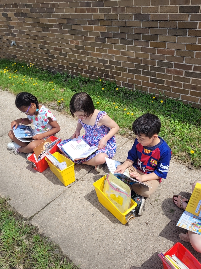 First graders reading outside.