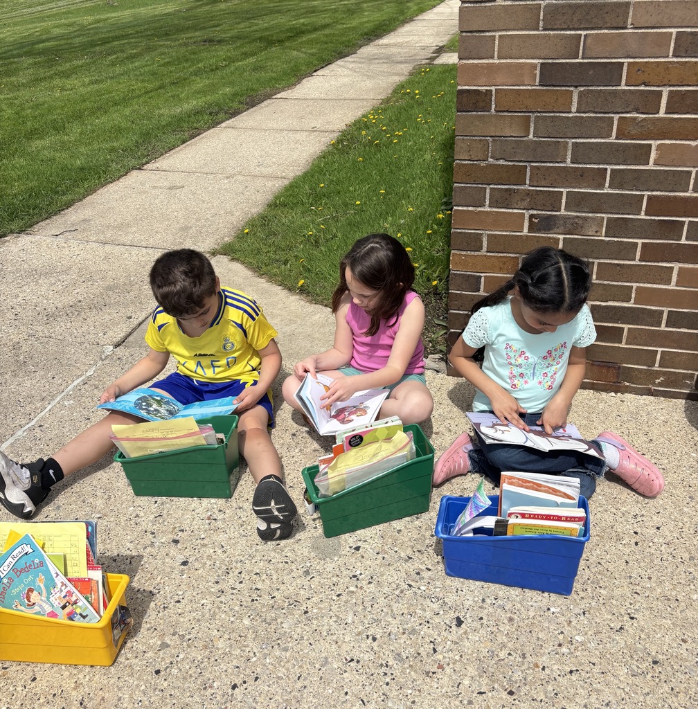 First graders reading outside.