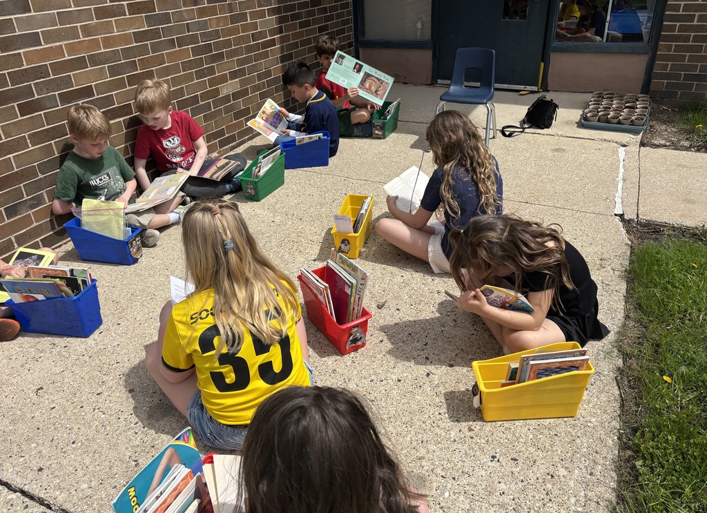 First graders reading outside.