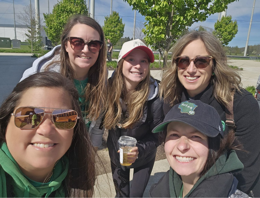 Smiling group of staffers at the all-school baseball field trip.