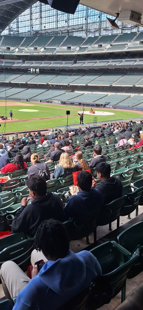 GHS students in the stands at a stadium listening to a presentation at a trades career fair.