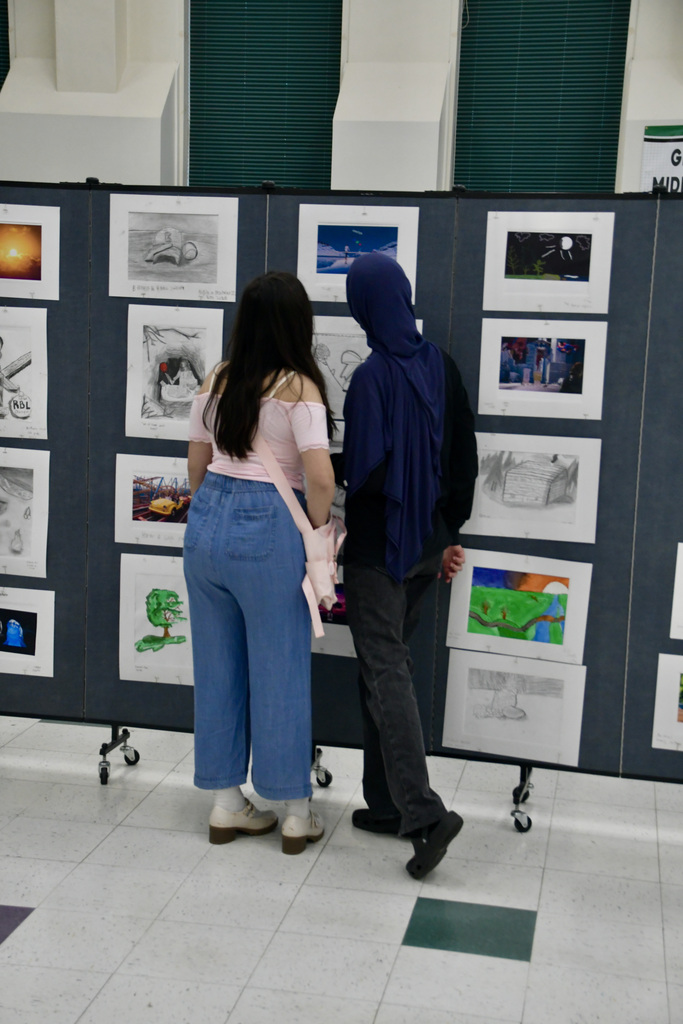 Two students checking out an art display at Gallery Night.
