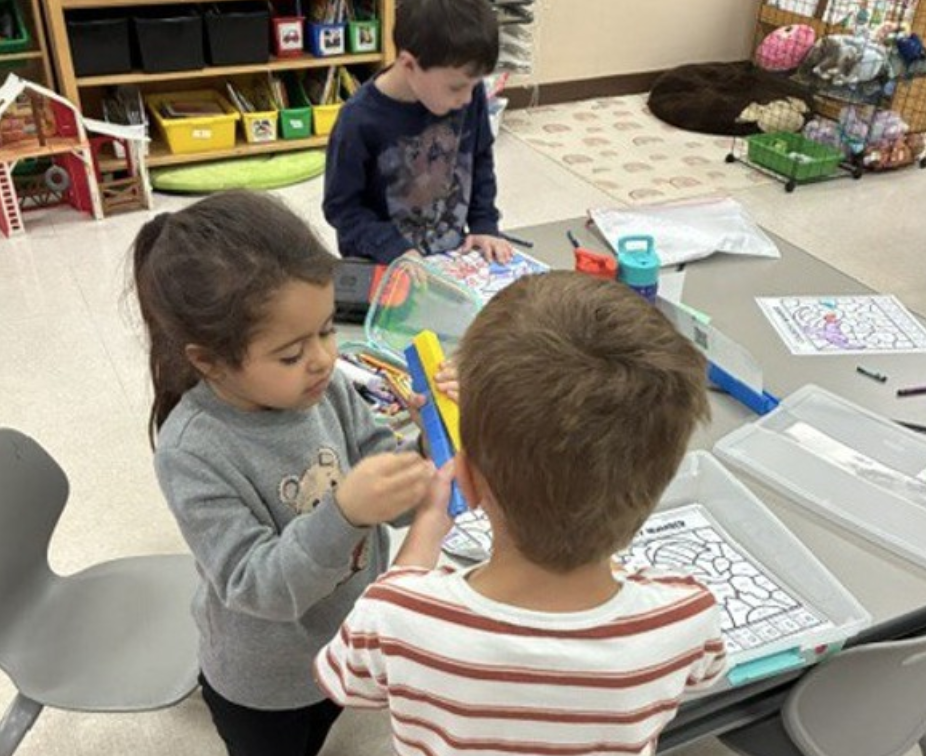 Three 5K students working at their desks.