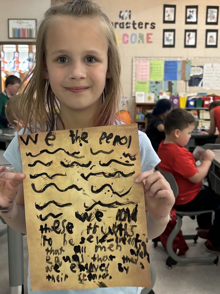 student showing her parchment paper writing