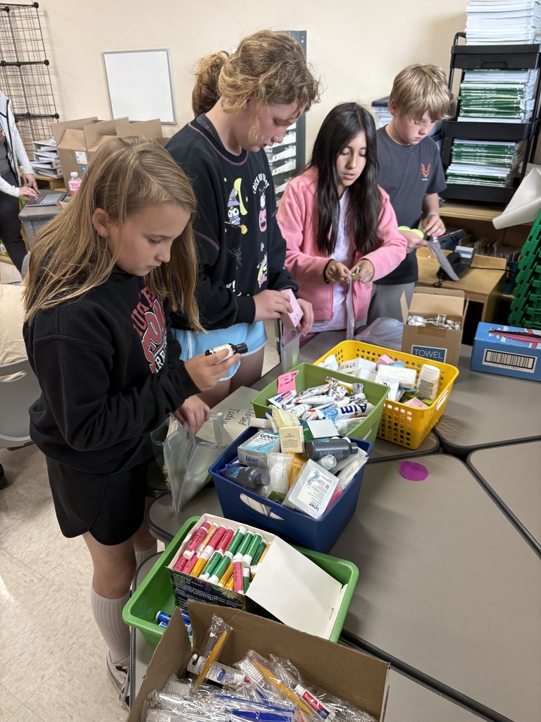 Students assembling personal hygiene kits.
