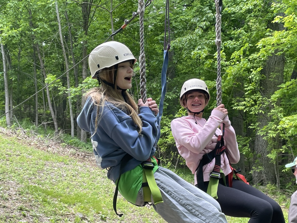 Two students swinging from ropes at Outdoor Ed.