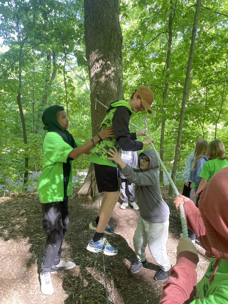 Students supporting each other on ropes course during team building at Outdoor Ed.