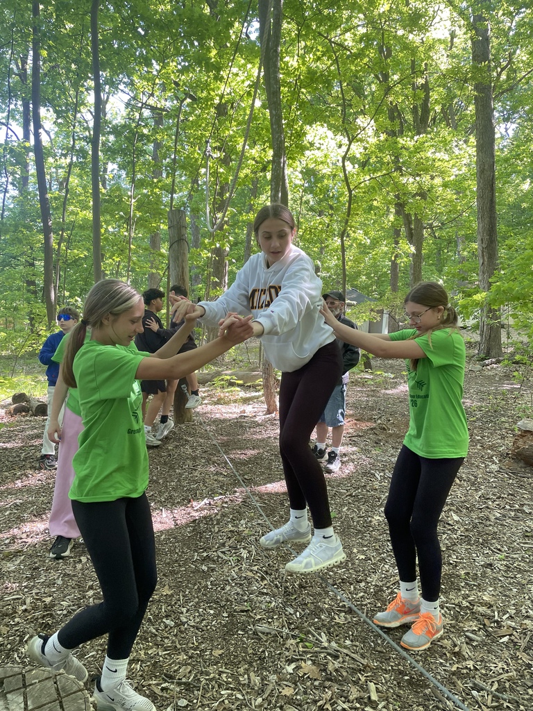 Students supporting each other on ropes course during team building at Outdoor Ed.