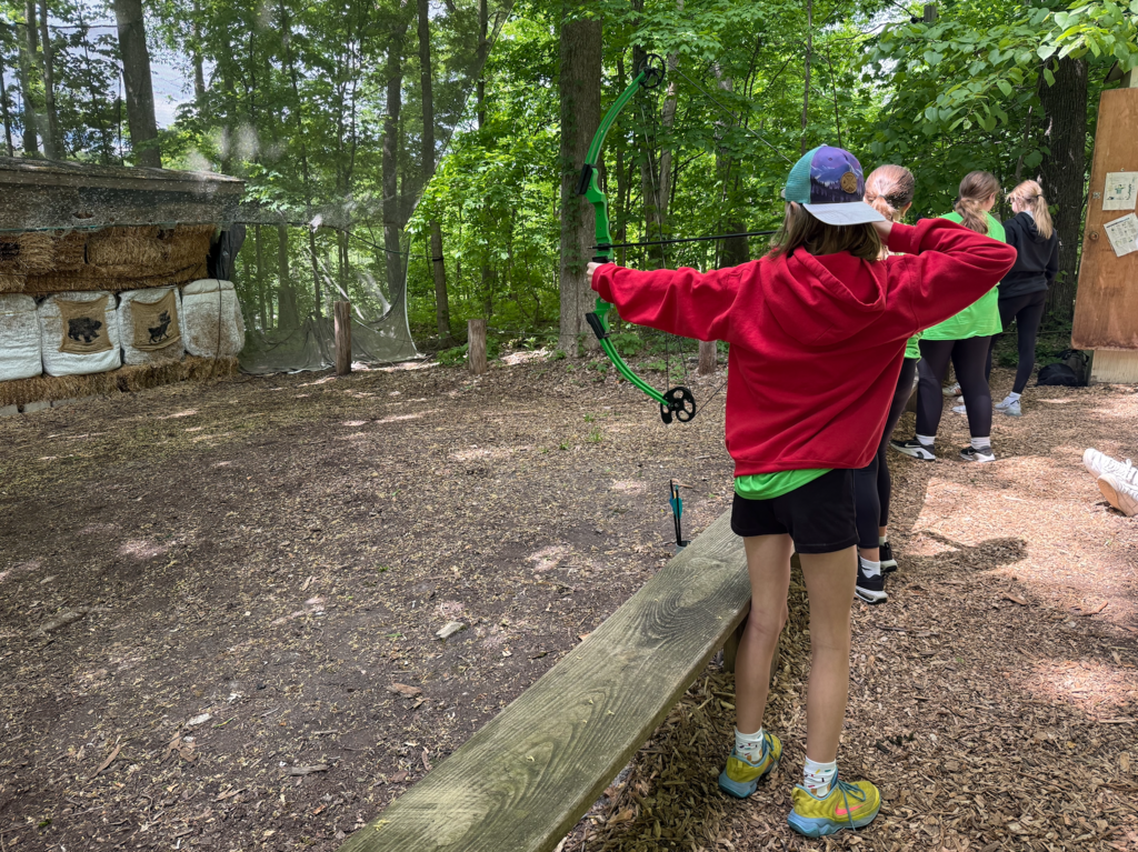 Students trying out archery at Outdoor Ed.
