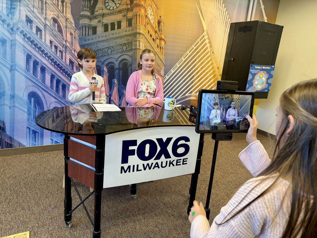 Students work in a TV newsroom during a Biztown field trip