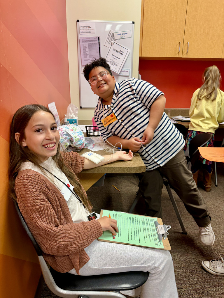 Students working in a medical office setting during a field trip to Biztown