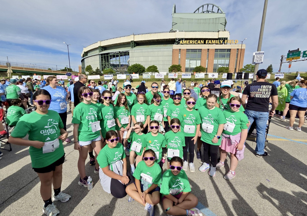 A big group of College Park Girls on the Run team members posed at AmFam field on they day of their 5K run.