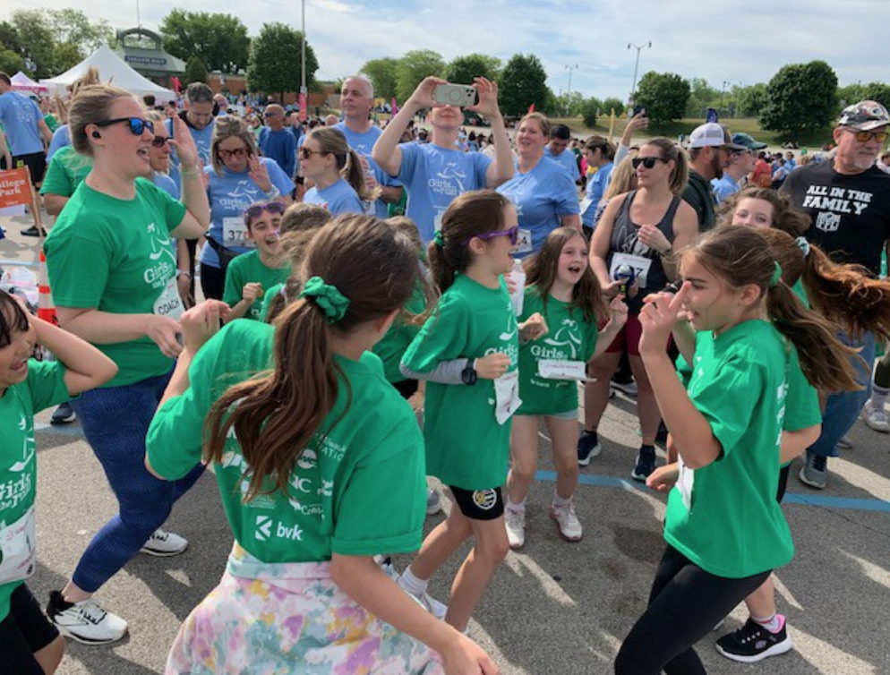 Some College Park Girls on the Run team members do a celebratory dance after their 5K race.