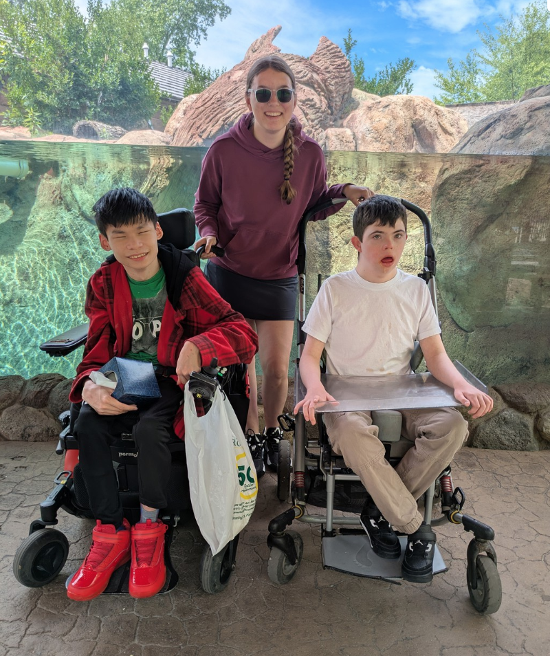Two students posing at an exhibit at the Zoo.