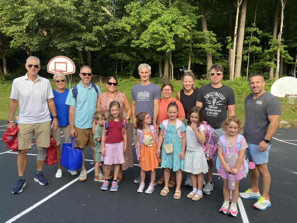Photo of students and parents, grand parents smiling at the camera.