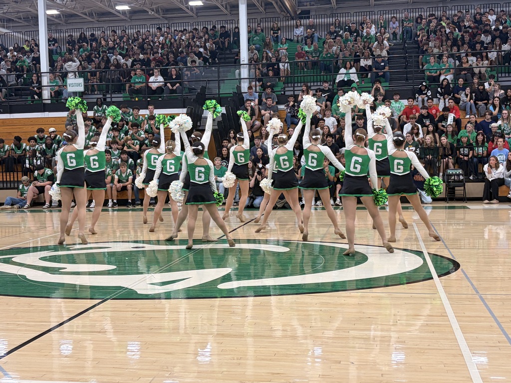 Back of the Poms team with the crowd from the school right ahead of them