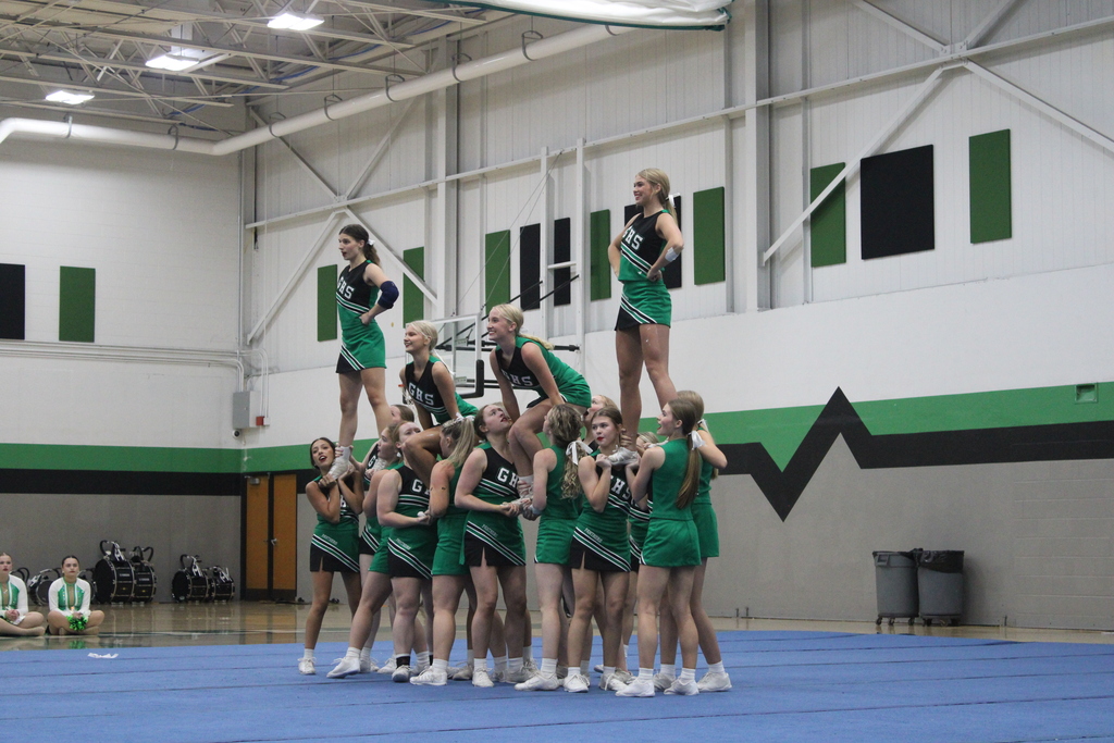 Cheer team posing in pyramid formation