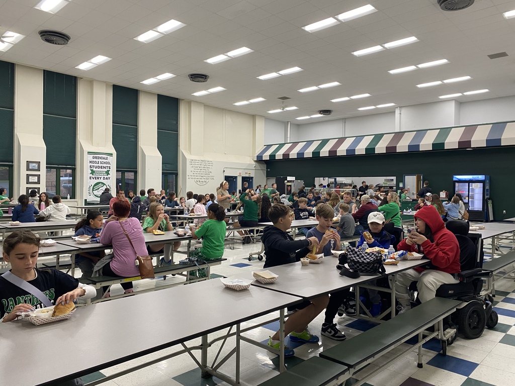 Students smiling and eating dinner in the cafeteria