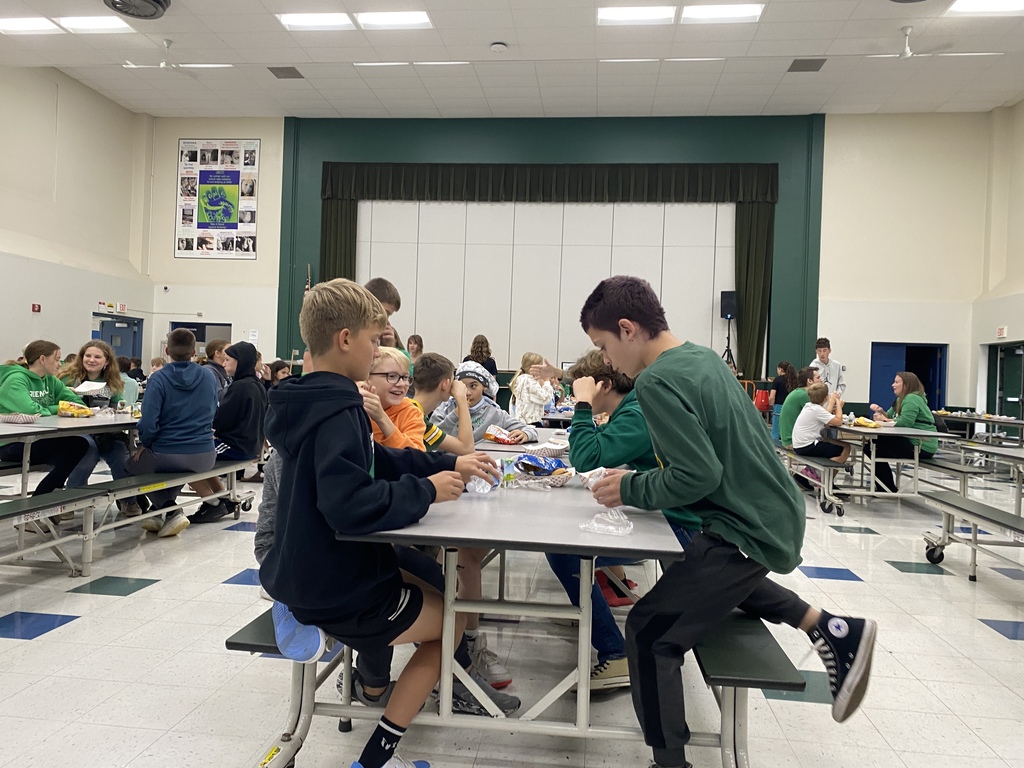 Students smiling and eating dinner in the cafeteria