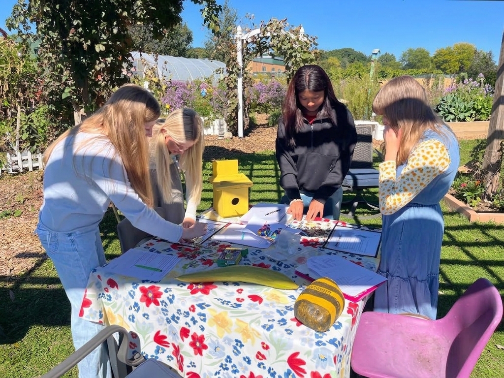 Students at a table reading prompts