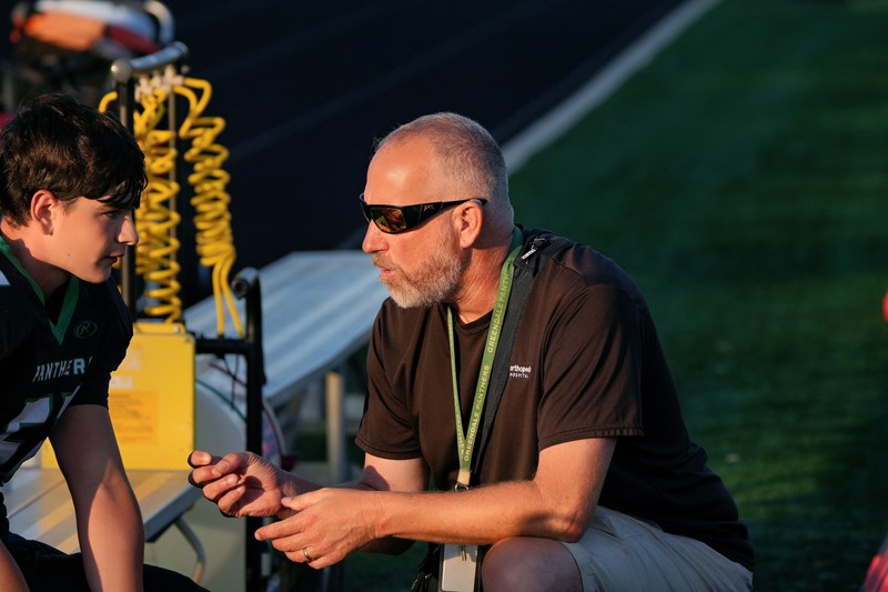 Chris Mackenzie speaking to a student