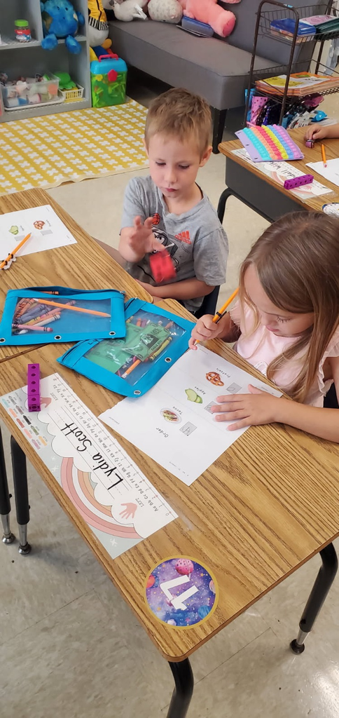 Mrs. Melissa's class having fun with learning. In math, we worked on subitizing and writing numbers by taking each other's order for tacos, apples, and pretzels.