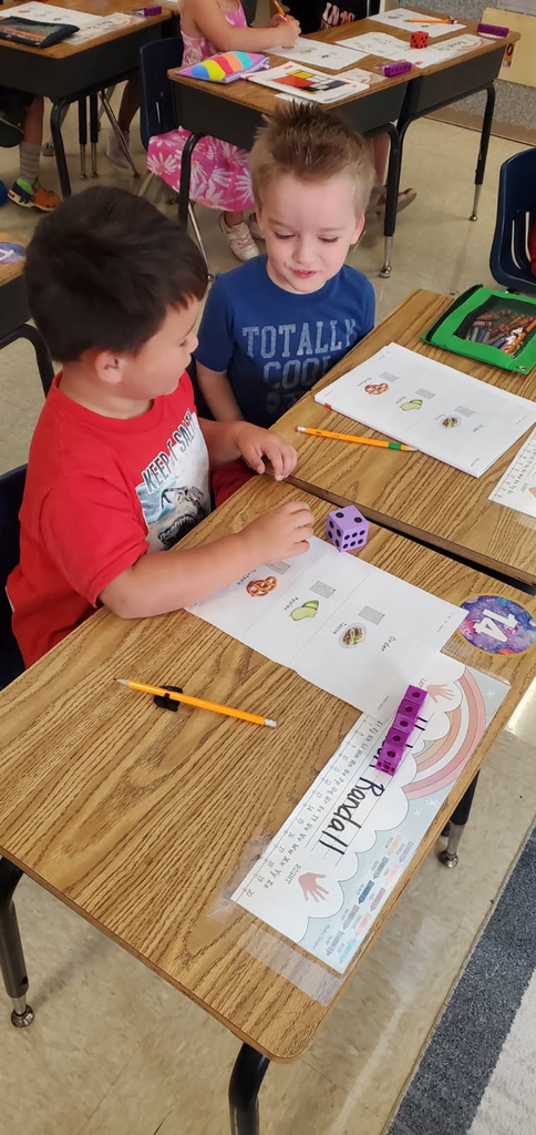 Mrs. Melissa's class having fun with learning. In math, we worked on subitizing and writing numbers by taking each other's order for tacos, apples, and pretzels.