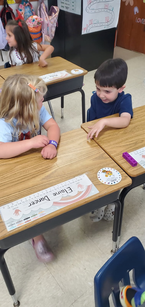 Mrs. Melissa's class having fun with learning. In math, we worked on subitizing and writing numbers by taking each other's order for tacos, apples, and pretzels.