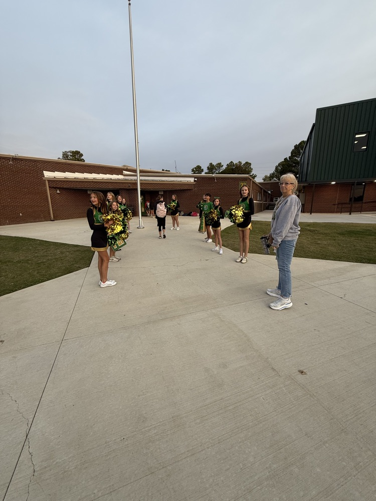 cheerleaders greeting students