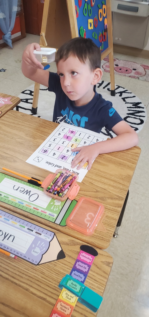 Mrs Melissa's class is making Math Fun ..Subitizing with Dice: Roll and Cover, and counting objects in a group with making Shape People!