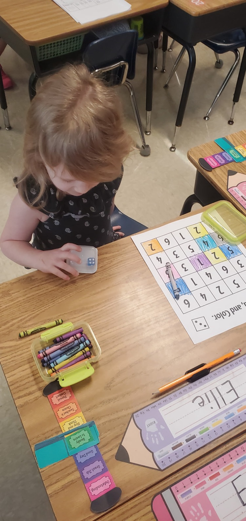 Mrs Melissa's class is making Math Fun ..Subitizing with Dice: Roll and Cover, and counting objects in a group with making Shape People!