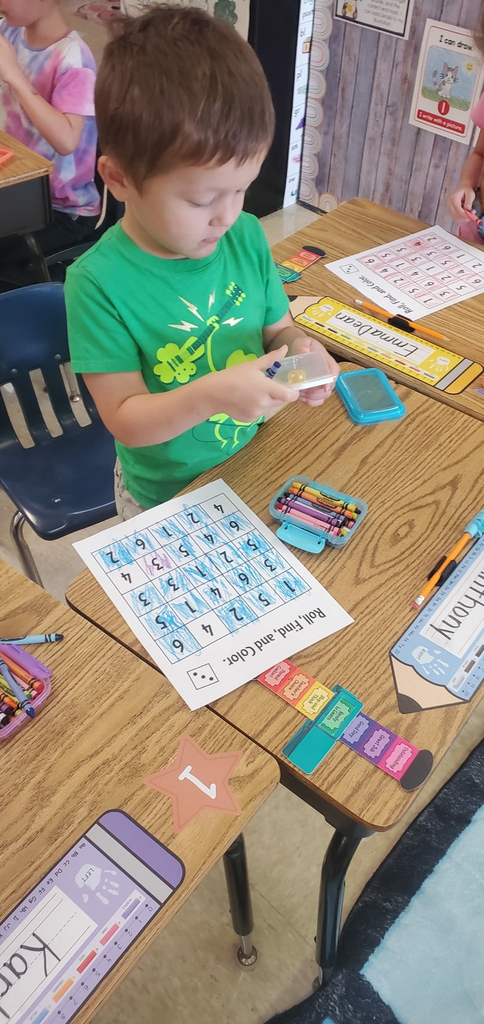 Mrs Melissa's class is making Math Fun ..Subitizing with Dice: Roll and Cover, and counting objects in a group with making Shape People!