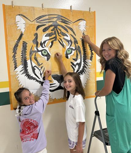Tusculum View fifth graders collaborate to work on a tiger mural. Shown, from left, are: Palmer Bailey, Phoebe Jones, Callee Catron. Photo Special To The Sun