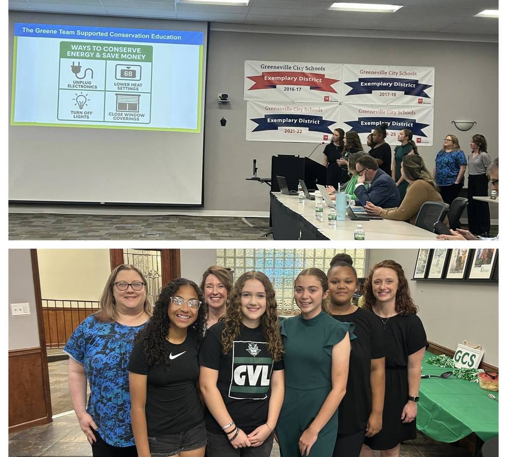 Two photos from a school board or district meeting. The top photo shows a presentation projected on a screen titled “The Greene Team Supported Conservation Education,” featuring icons and tips for conserving energy such as unplugging electronics, lowering heat settings, turning off lights, and closing window coverings. Several people stand at a podium presenting while others sit at a long table with laptops, microphones, and water bottles. Banners on the wall read “Greenville City Schools Exemplary District” with multiple school years listed. The bottom photo shows a group of adults and students standing in a row indoors near a table covered with a green tablecloth and a “GCS” sign. Everyone faces the camera, and a glass block wall and framed items are visible in the background.