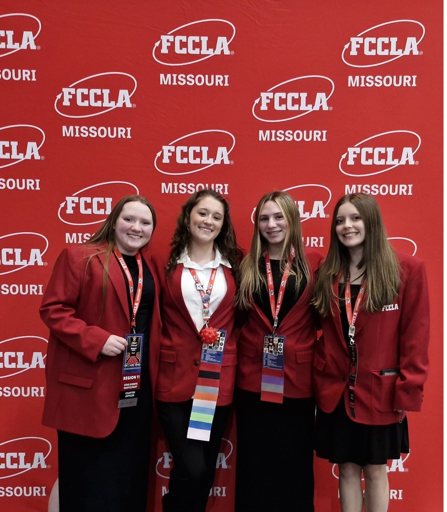 photo of Greenfield High School students Layla Webb, Stormy Turnbough, Abigale Maxwell, and Ezabella Vesco in front of red backdrop with white FCCLA Missouri Logos