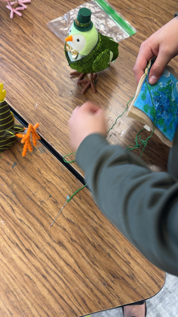fourth graders practicing their sewing skills in art class