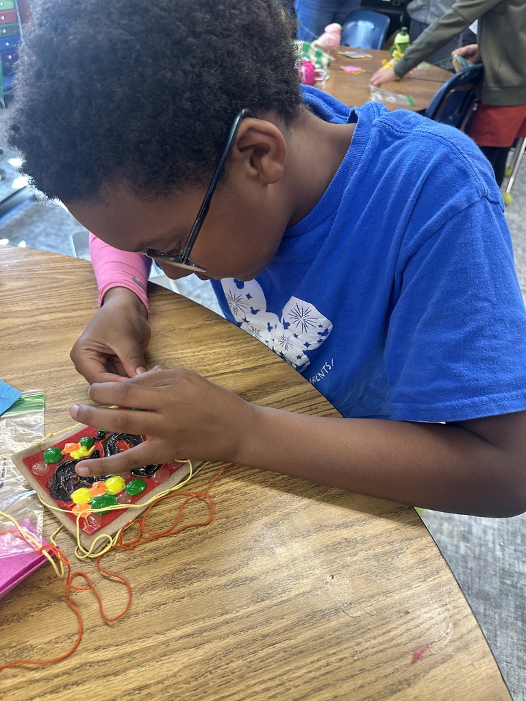 fourth graders practicing their sewing skills in art class