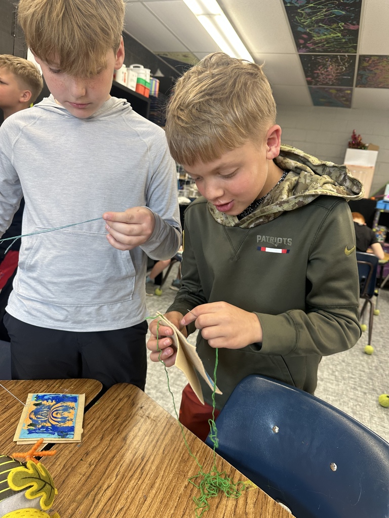 fourth graders practicing their sewing skills in art class
