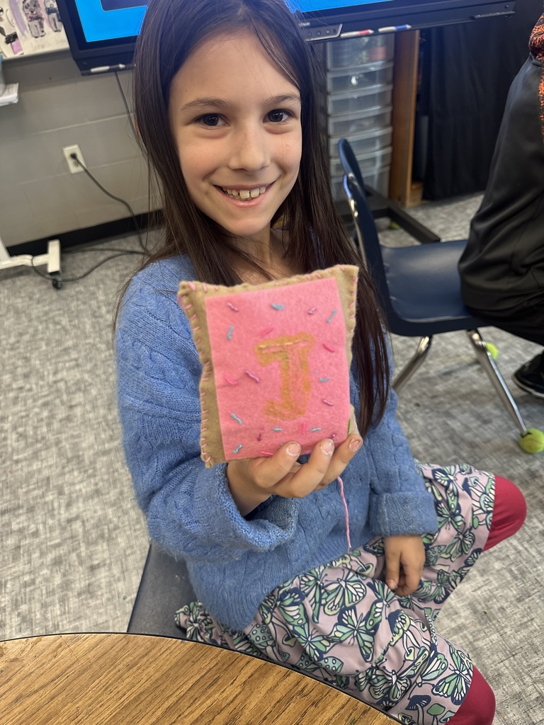 fourth graders practicing their sewing skills in art class