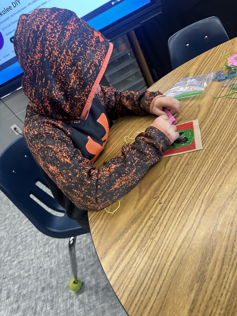 fourth graders practicing their sewing skills in art class