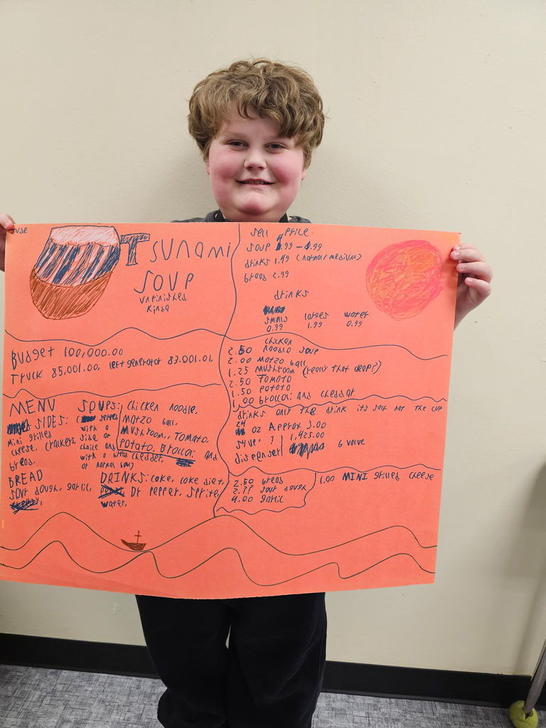 student holding up a menu to tsunami soup 