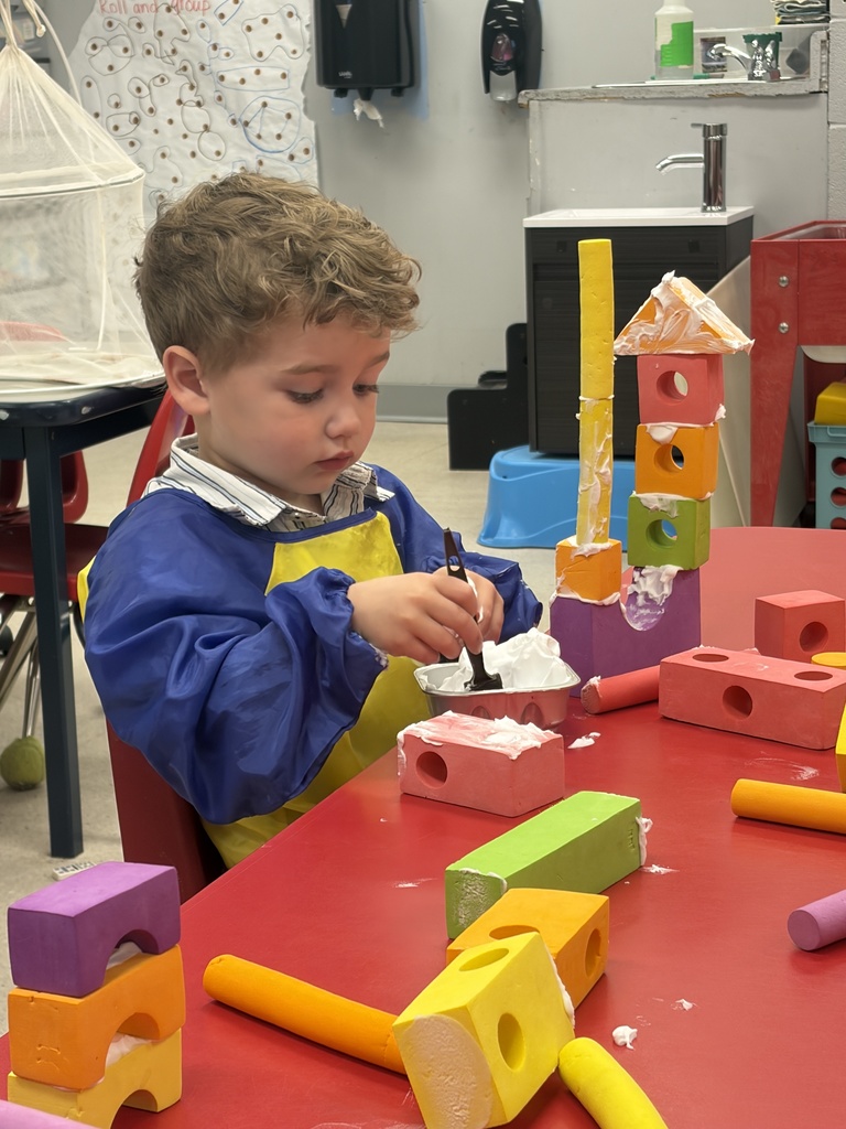 preschool student building a treehouse with blocks