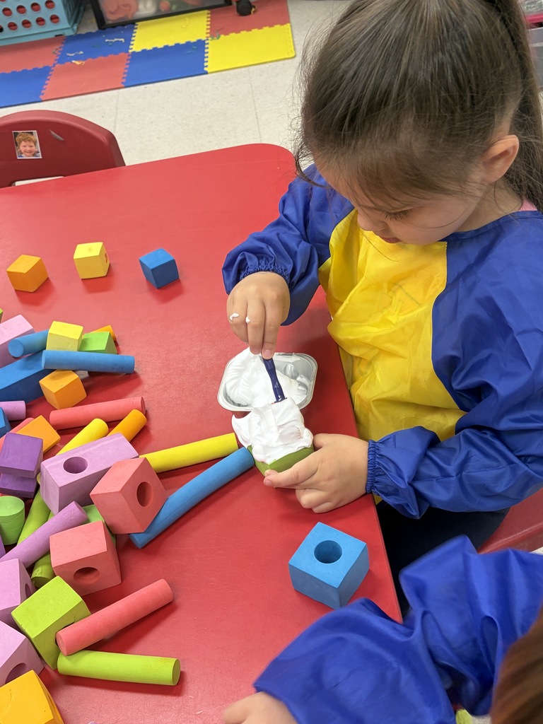 preschool student building a treehouse with blocks