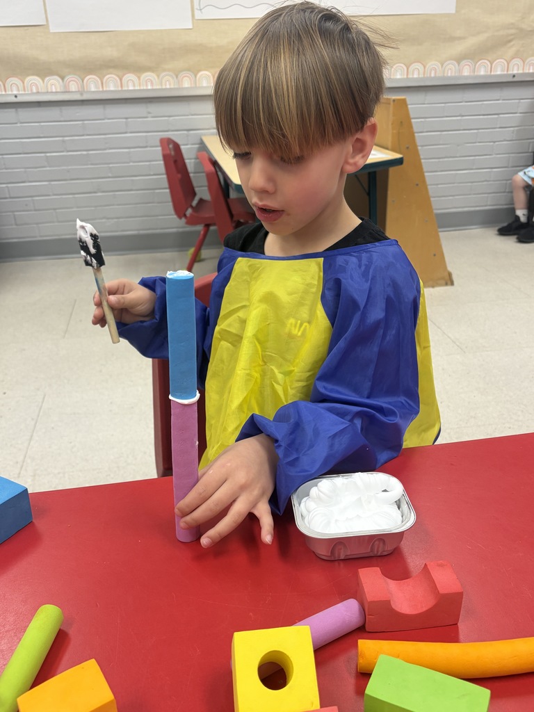 preschool student building a treehouse with blocks
