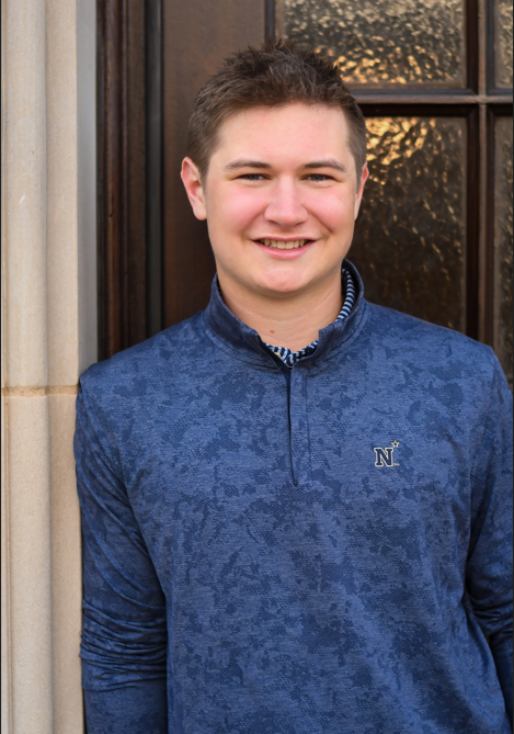 student posing in naval academy shirt for his entry recognition