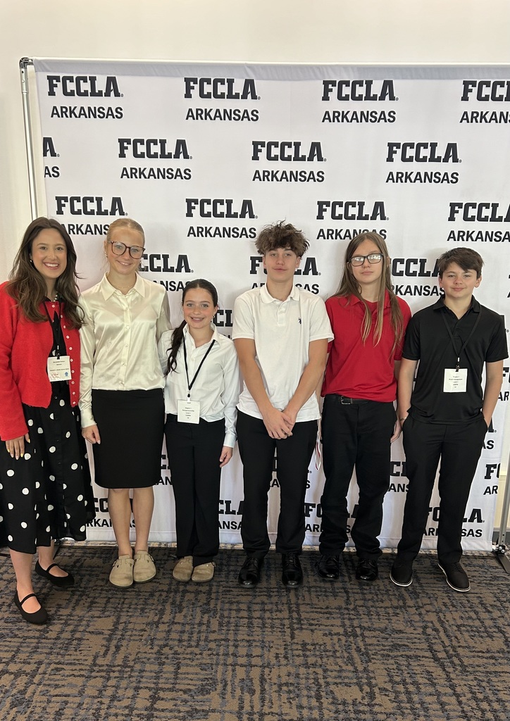 six students posing in front of the fccla banner