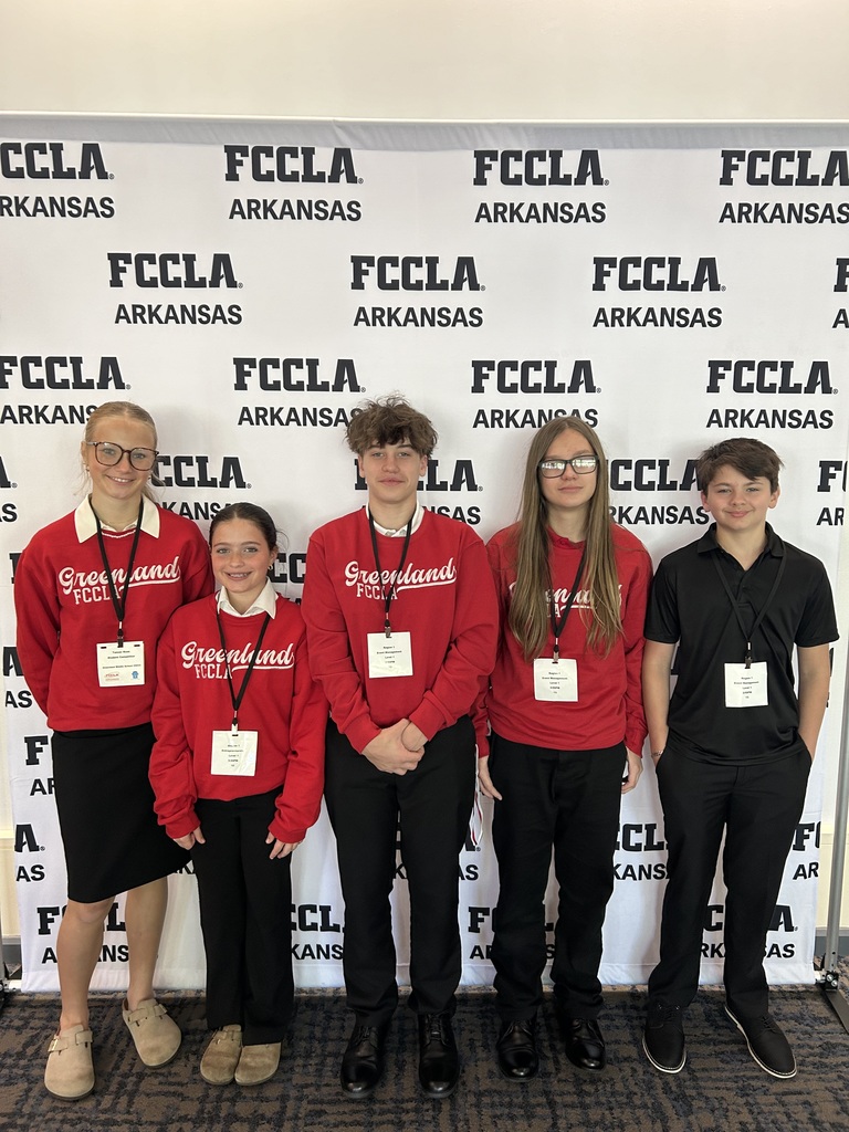 five students posing in front of the fccla banner