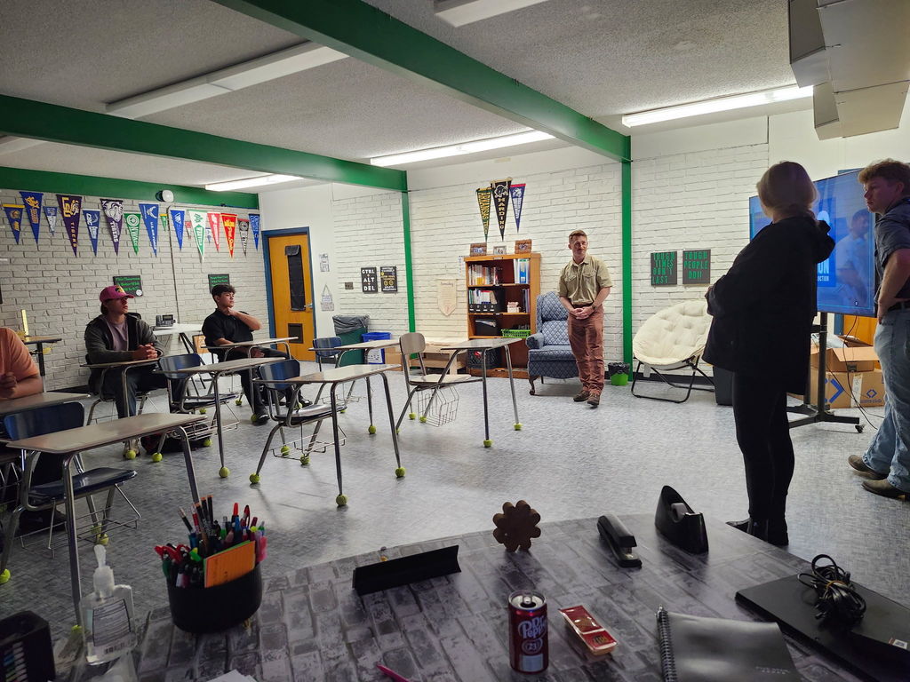 students in a classroom looking at a presentation