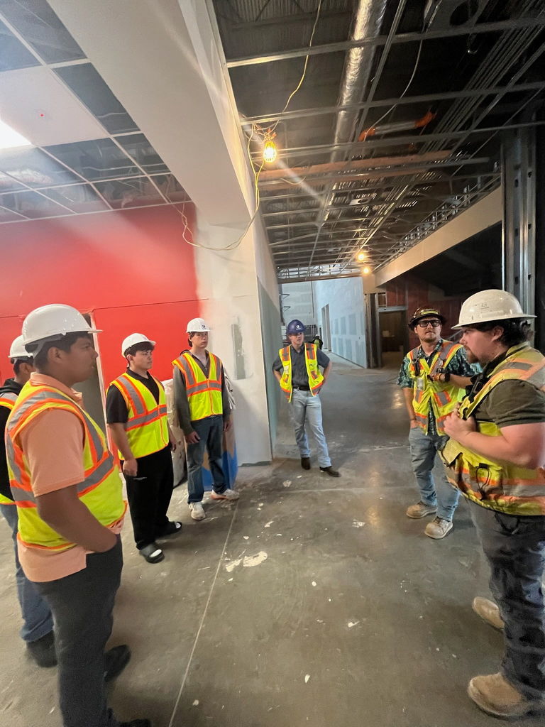students standing inside of a building being constructed